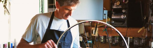 Lennard Zinn of Zinn Cycles working on custom wheelset for bikes